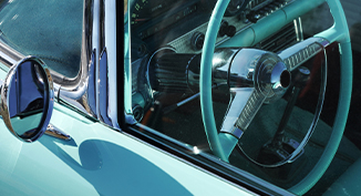 close up of outside of drivers side of a classic car